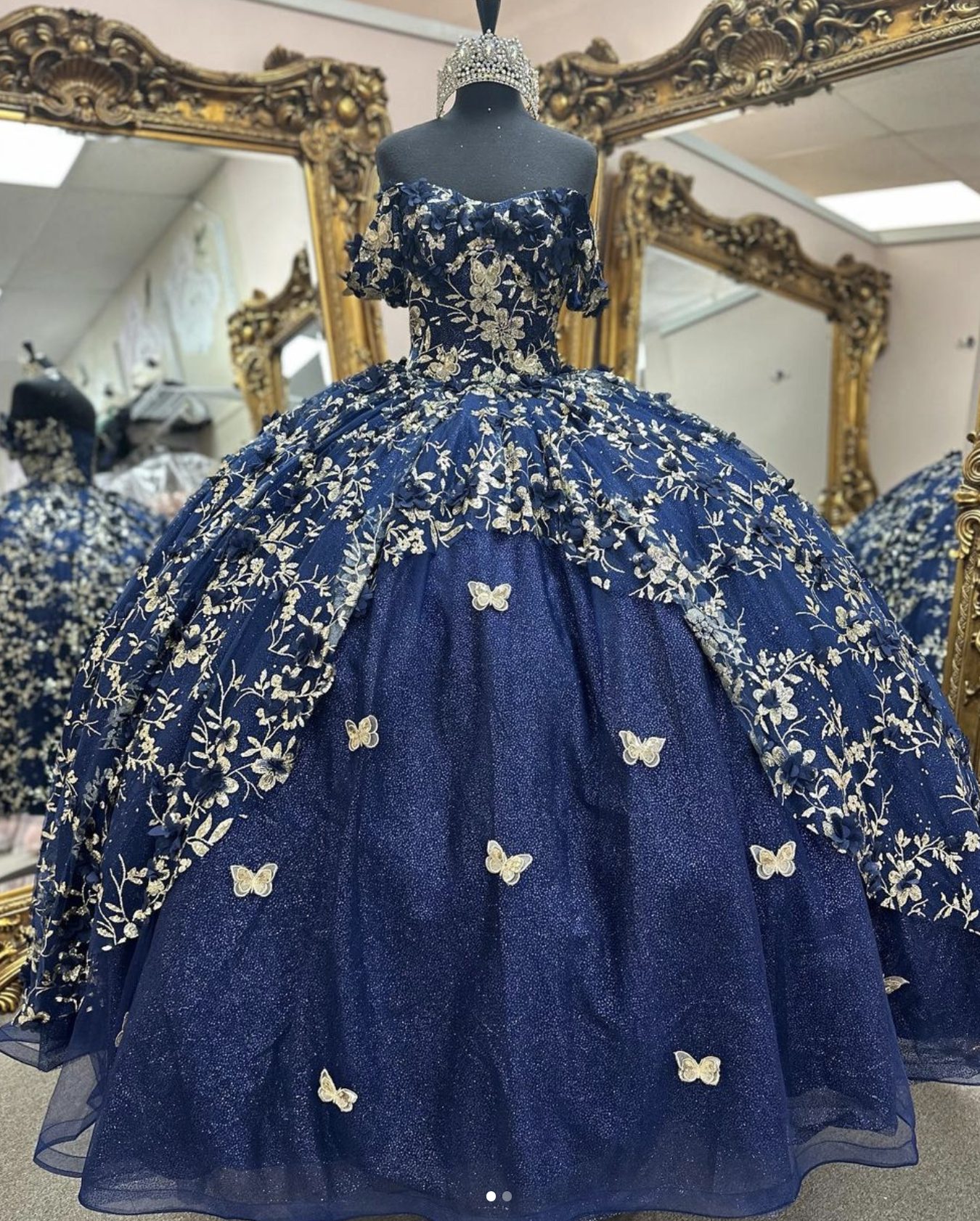 Navy blue quinceañera ball gown with gold butterflies and floral embroidery