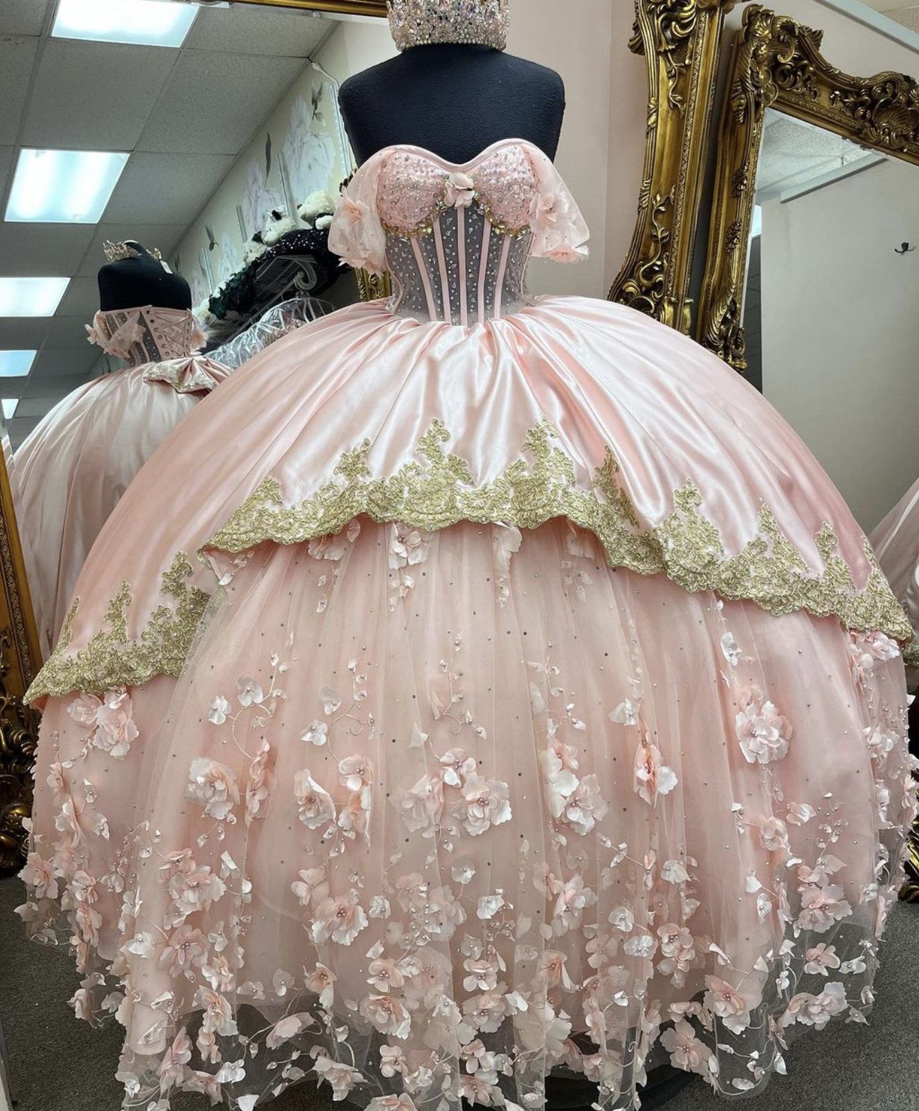Blush pink quinceañera ball gown with gold lace appliqué and floral tulle skirt